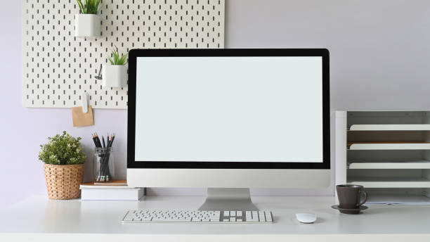 istock Workspace is surrounding by a white blank screen computer monitor and office equipment. 1250985263