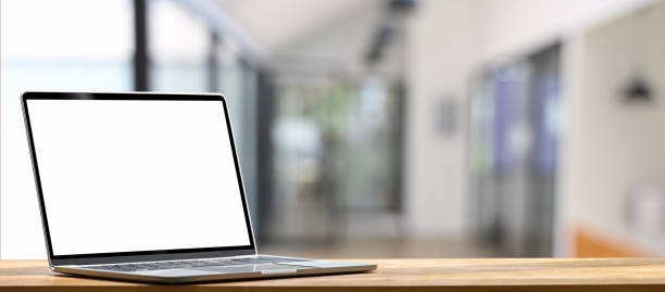 istock Laptop is putting on a wooden working desk over blurred background. 1250985345