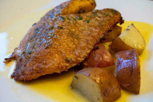 istock Parmesan Crusted Tilapia with Potatoes with a Beurre Blanc 1250986575