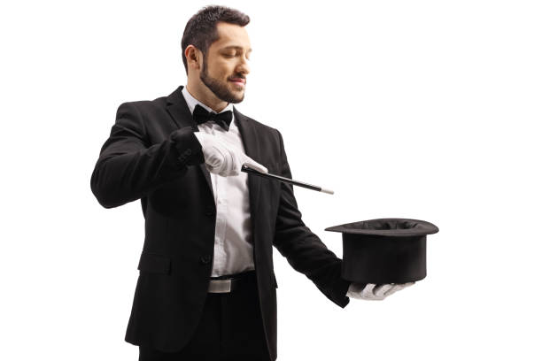 istock Magician performing a trick with a magic wand and a top hat 1250987981