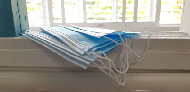 istock A pile of blue face protection masks lay on a window 1250989904