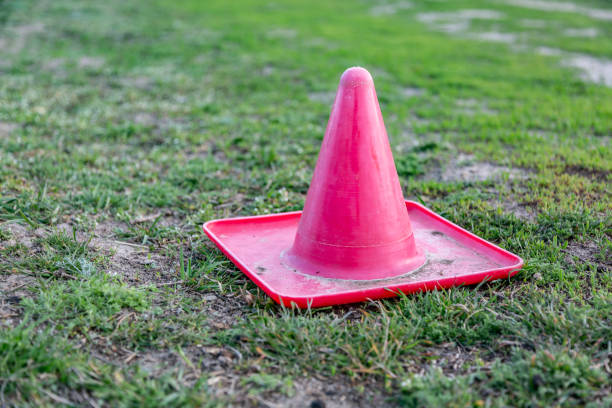 istock Red plastic little cone on the grass. Horizontal orientation 1250992927