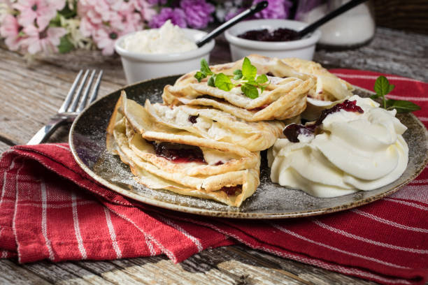 istock Crepes with ricotta cheese and blackcurrant jam. 1250994390