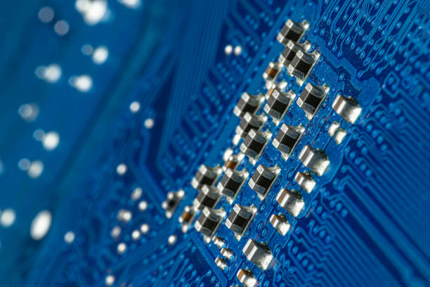 istock Macro photo of electrical paths on blue circuit board, visible resistors. 1250995173