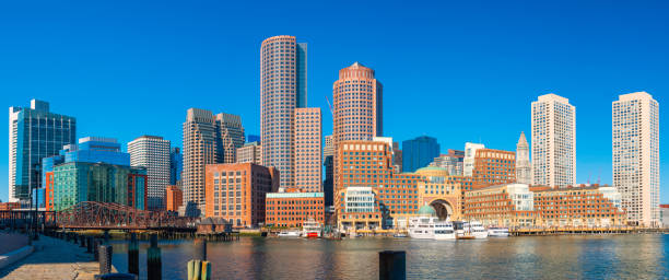 panoramic boston city skyline and seascape at the boston harbor. clear blue sky backgrounds. - boston skyline harbor city imagens e fotografias de stock