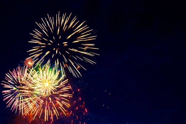 istock 4th July fireworks. Fireworks display on dark sky background 1250998353