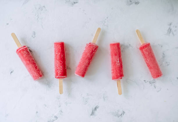 istock Pink fruit ice sorbet on a white background. Stick ice cream. Close up 1250998424