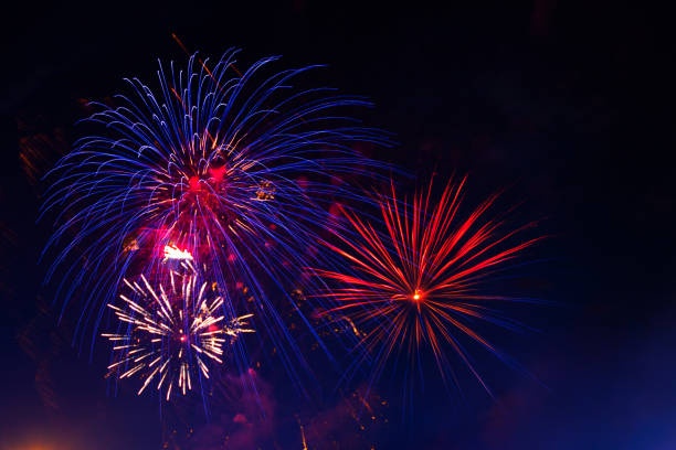 istock 4th July fireworks. Fireworks display on dark sky background 1250998482