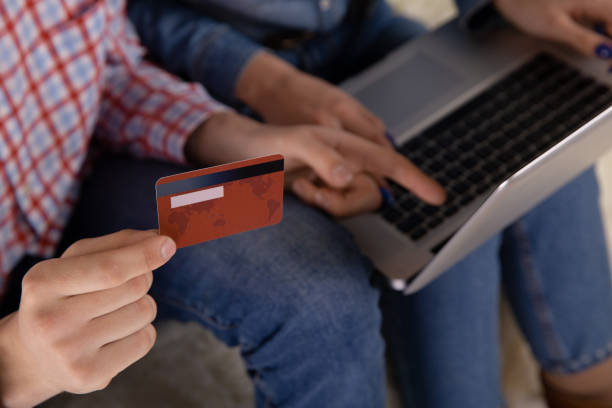 istock Couple online shopping concept. Credit card in the hand. Using computer. 1250999213