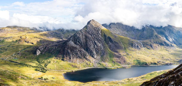 The mountain Tryfan and Ogwen lake A panoramic view of the well known mountain in the Ogwen valley North Wales. Very popular peak for scrambling, one of the two summit stones can be seen on top snowdonia stock pictures, royalty-free photos & images