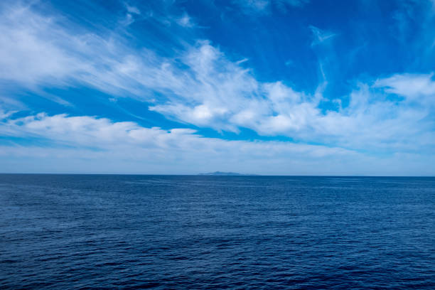 istock Blue sea and sky background, blue shades and white clouds 1251001158