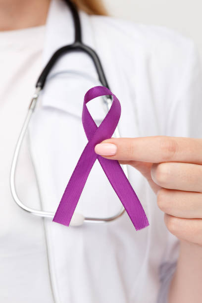 istock Purple ribbon in the doctor's hand isolated. 1251001717
