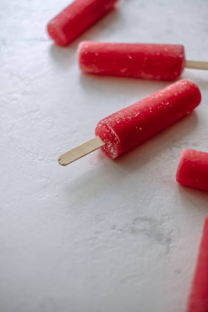 istock Pink fruit ice sorbet on a white background. Stick ice cream. Close up 1251002186