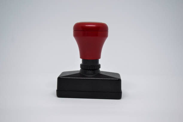 istock Close up Red Handle Rubber Stamper isolated on White Background. 1251004133