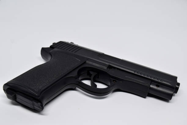 istock Close up black handgun isolated on White Background. criminal concept 1251004201