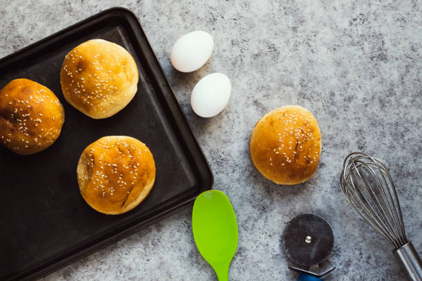 istock homemade burger buns with sesame on wooden board 1251004855