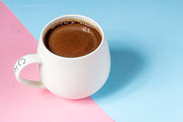 istock Black coffee in a white big cup on a pink and blue background 1251004991