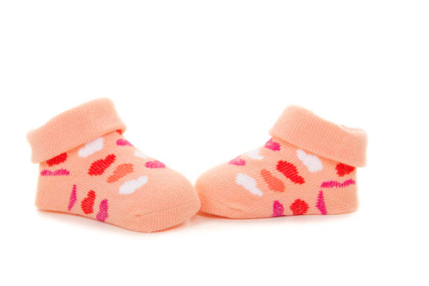 istock Pink orange baby socks with hearts isolated on a white background 1251005383