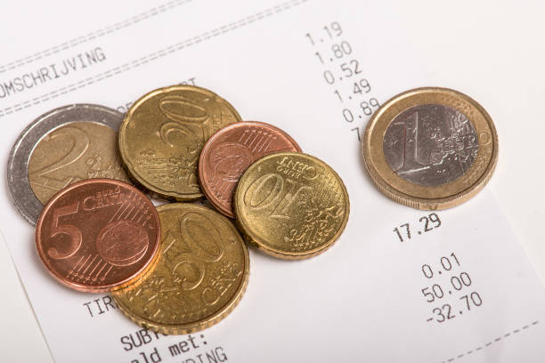 istock Different euro coins lying on a receipt ticket 1251006275
