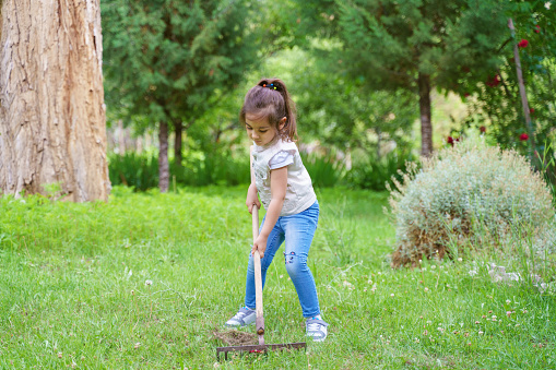 Little girl helping in a garden
