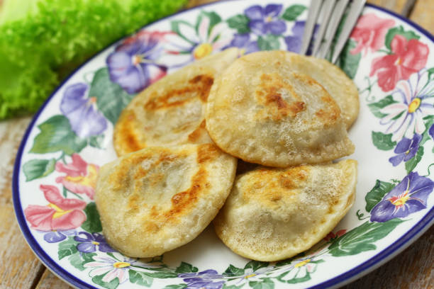 istock Traditional, fried Polish dumplings on colorful vintage plate 1251006599