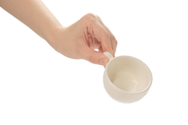 istock Empty coffee cup in woman hand isolated on white. 1251007324