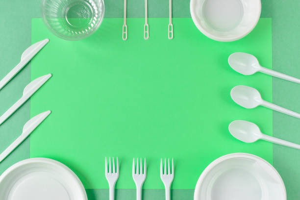 istock Frame of plastic utensils on a green background. 1251007695