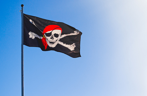 Jolly Roger pirate flag and sky.