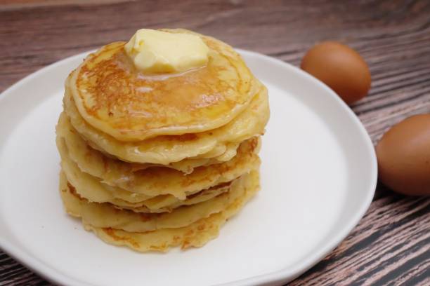 istock In selective focus butter pancake in a white plate with blurred eggs 1251010351