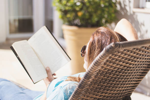 istock Woman at home reading an analog book. 1251012589