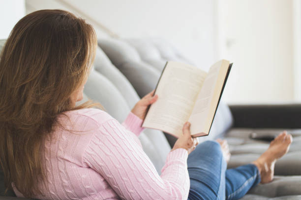 istock Woman at home reading an analog book. 1251012596