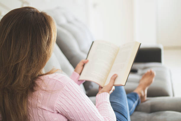 istock Woman at home reading an analog book. 1251012623
