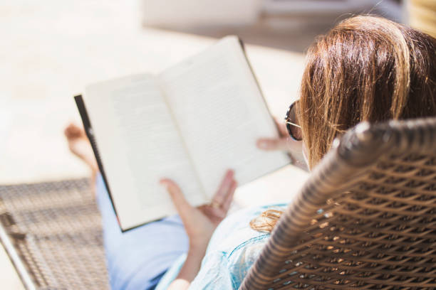 istock Woman at home reading an analog book. 1251012625
