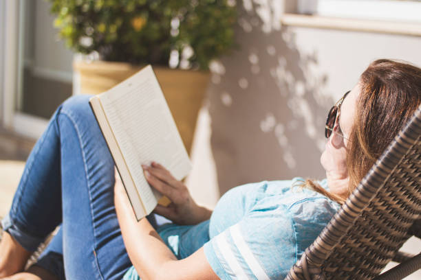 istock Woman at home reading an analog book. 1251012626