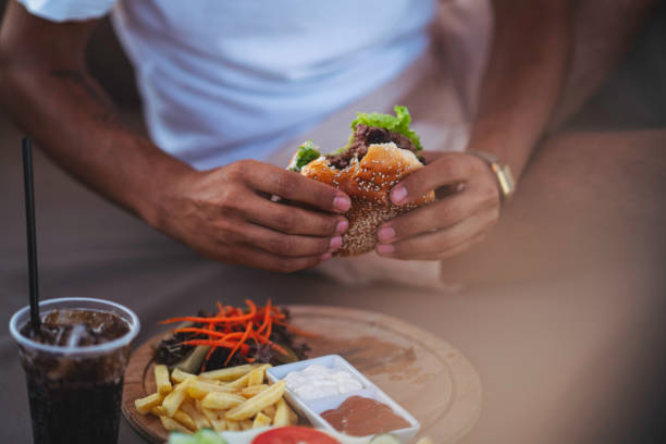 istock Delicious hamburger, chips and onion rings 1251014113