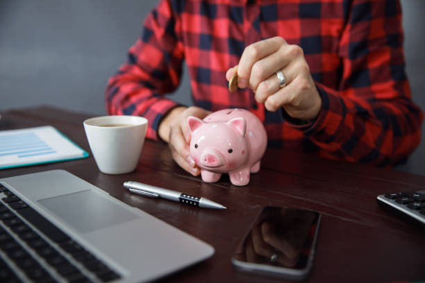 istock man hand coin with piggy bank 1251015183