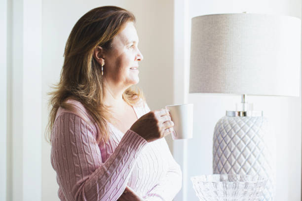 istock Woman looking by the window. 1251015198