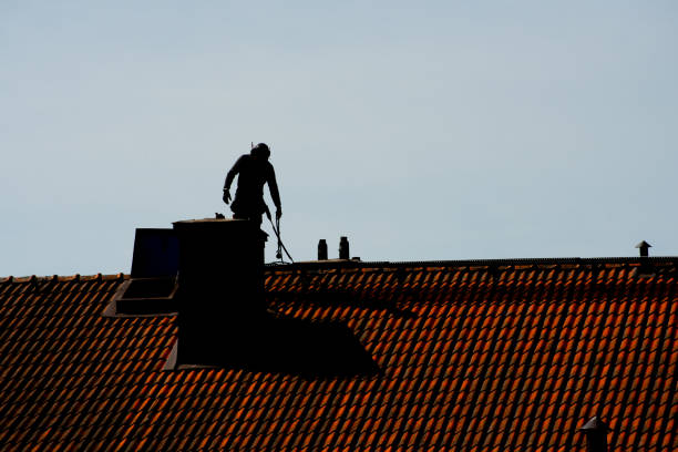 Silhouette of a chimney sweeper on top of a roof Silhouette of a chimney sweeper on top of a roof. sweeping photos stock pictures, royalty-free photos & images