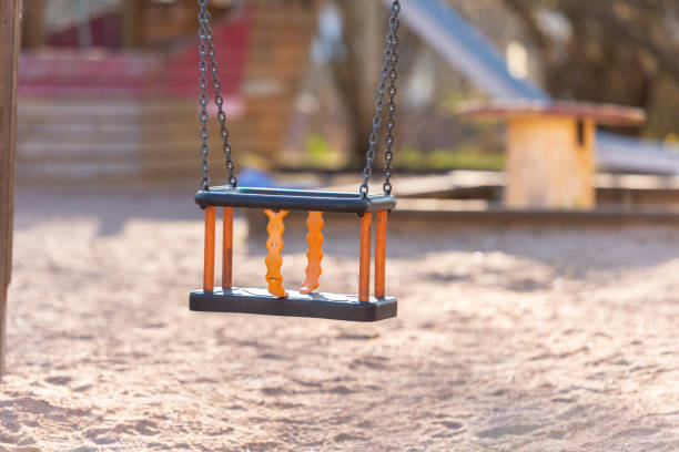 istock An empty baby swing in a playground 1251016478
