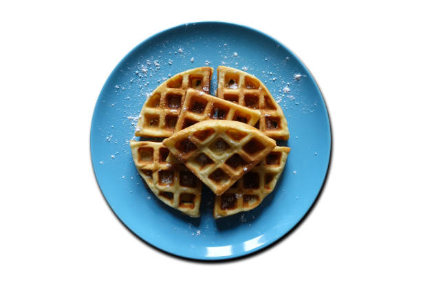 Baked waffles with powdered sugar on a blue plate