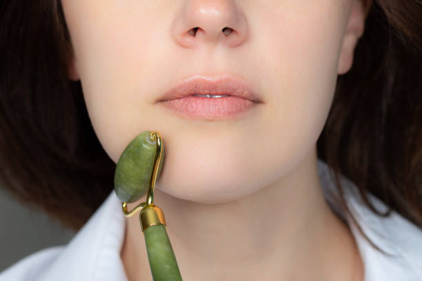 istock Woman with jade face roller 1251022666