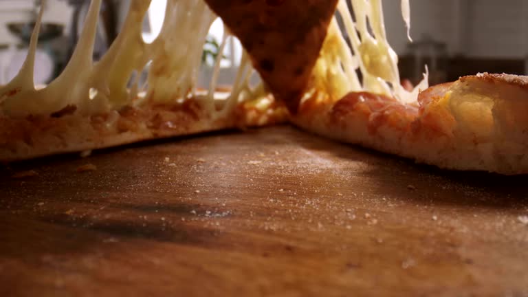 Preparing Pizza with Prosciutto Ham and Fresh Basil in Domestic Kitchen