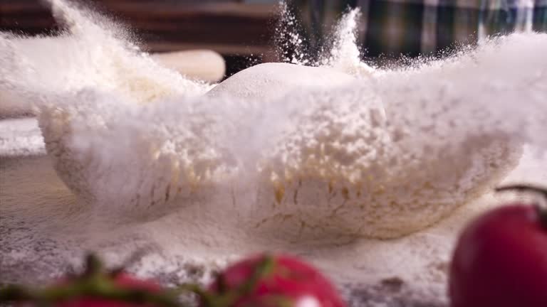 Super Slow Motion Video of Woman's Hands Sprinkling Flour over Pizza Dough 1000 fps