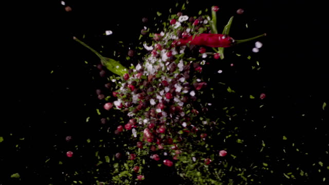 Parsley, Peppercorns, Bay Leaves, Oregano, Sea-Salt, Chili Pepper, Rosemary Colliding in the Air Super Slow Motion Video 1000 fps