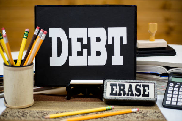 istock Word DEBT on chalkboard with eraser. 1251035186