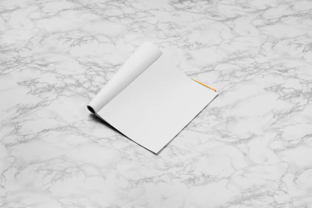 istock Mock-up magazine, newspaper or catalog isolated on white marble background. 1251036978