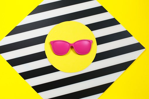 Painted pink Fashion sunglasses on colorful background. Geometry concept, minimalism. Pop Art. Sunny summer Still life. Bright Sweet fashion Style.