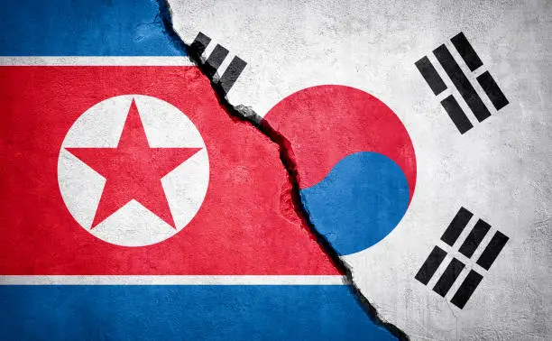 North Korea and South Korea conflict. Country flags on broken wall. Illustration.