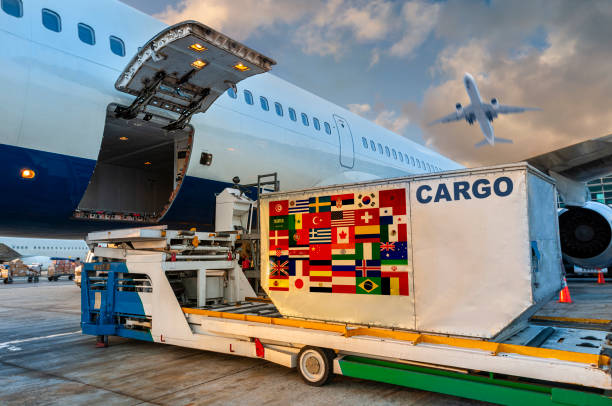 Loading the container in the cargo airplane. Loading the container with a Many countrie flags in the cargo airplane. industrial ship photos stock pictures, royalty-free photos & images