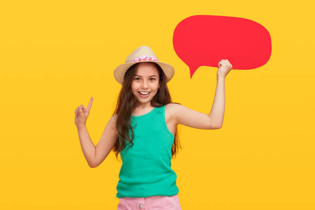 istock Happy girl with empty speech bubble pointing up 1251044414